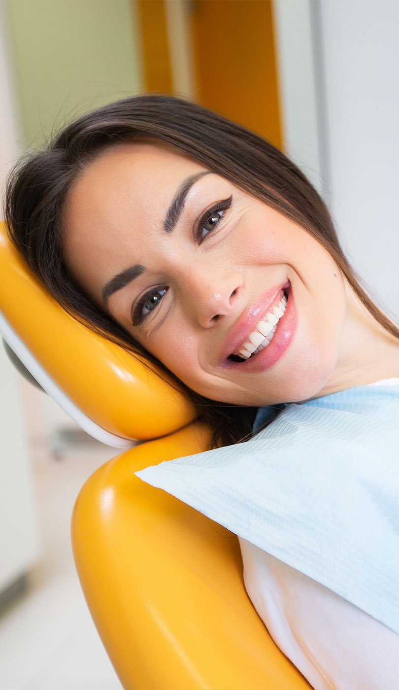 The image shows a modern dental or medical office interior with a dental chair, equipment, and a clean, professional environment.