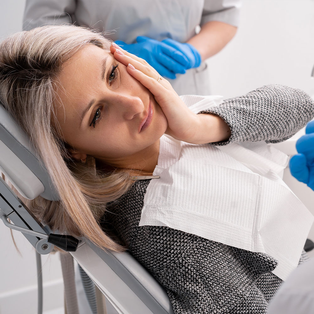 A person is holding up a small, clear plastic tray with a single toothbrush-shaped object inside it.